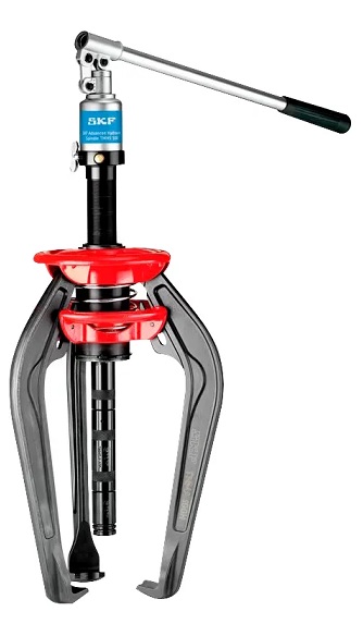 DAKAM – Demontaż wagi ciężkiej. Oryginalny TMMA 100H od ręki. Najpotężniejszy Zintegrowany Ściągacz SKF TMMA 100H w DAKAM Obraz jest ucieleśnieniem maksymalnej mocy w kompaktowej formie. Prezentuje najsilniejszy model z serii zintegrowanych ściągaczy – SKF TMMA 100H. Kompozycja ma na celu wizualne podkreślenie różnicy skali i siły (100 kN / 10 ton) w porównaniu do mniejszych modeli, przy jednoczesnym zachowaniu mobilności. Całość osadzona jest w realiach profesjonalnego serwisu wspieranego przez autoryzowanego polskiego dystrybutora DAKAM. Dominują barwy: głęboka czerń korpusu, szczotkowana stal ramion i czerwień (uchwyt/dźwignia). 10 ton siły demontażu w jednym narzędziu: W centrum uwagi, na wzmocnionym stole warsztatowym (sugerującym pracę z cięższymi elementami), dominuje ściągacz hydrauliczny SKF TMMA 100H: • Masywny Korpus: Widoczny jest korpus urządzenia, który jest wyraźnie większy i bardziej masywny niż w modelu 75H. To wizualizacja siły 100 kN (10 ton), która jest generowana wewnętrznie, bez potrzeby podłączania zewnętrznych pomp. • Ergonomiczna Dźwignia: Długa, solidna dźwignia pompy jest uchwycona w pozycji gotowej do pracy. Ujęcie sugeruje, że mimo ogromnej siły, narzędzie jest obsługiwane ręcznie, w sposób ergonomiczny. • Wydłużone Ramiona: Prezentowane są długie ramiona ściągacza, które pozwalają na głęboki chwyt (większy zasięg niż w mniejszych modelach). Mechanizm sprężynowy EasyPull jest widoczny, pokazując, jak ramiona automatycznie zaciskają się za demontowanym elementem. • Zawór Bezpieczeństwa: Detal na korpusie – zawór przeciążeniowy, który jest gwarantem bezpieczeństwa przy operowaniu tak dużymi siłami. • Marka Premium: Na czarnym tle korpusu widoczne jest kontrastowe, białe logo "SKF" oraz wyraźne oznaczenie modelu "TMMA 100H", co pozycjonuje produkt jako topowe rozwiązanie w swojej klasie. Sprawdzony Polski Dystrybutor DAKAM: Tło jest subtelnie rozmyte, ale buduje autorytet dostawcy: • Duża Walizka: Obok narzędzia stoi otwarta, duża walizka transportowa dedykowana dla modelu 100H (często z kółkami lub solidnym uchwytem ze względu na wagę). • Magazyn DAKAM: W tle widać regały z produktami Heavy Duty, co potwierdza, że DAKAM specjalizuje się w dostarczaniu narzędzi do najcięższych zadań. • Logo Dystrybutora: W dyskretnym, ale widocznym miejscu umieszczone jest logo DAKAM, z dopiskiem "Autoryzowany Dystrybutor Narzędzi SKF". Obraz niesie jasny komunikat: "W DAKAM dostępny jest najsilniejszy zintegrowany ściągacz na rynku – SKF TMMA 100H. To 10 ton czystej siły hydraulicznej, zamknięte w przenośnym urządzeniu, gotowym do demontażu dużych łożysk i kół zębatych bez zewnętrznego zasilania".